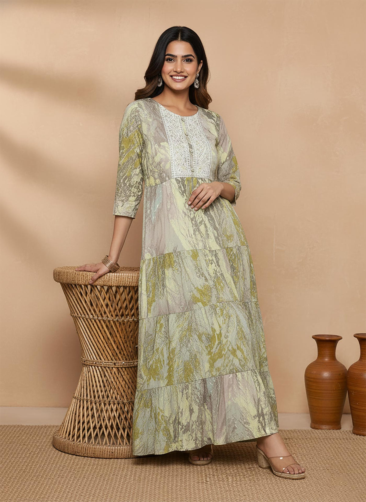 Multicolor olive abstract print maxi dress with embroidered yoke, flared tiers, styled with wedge heels.