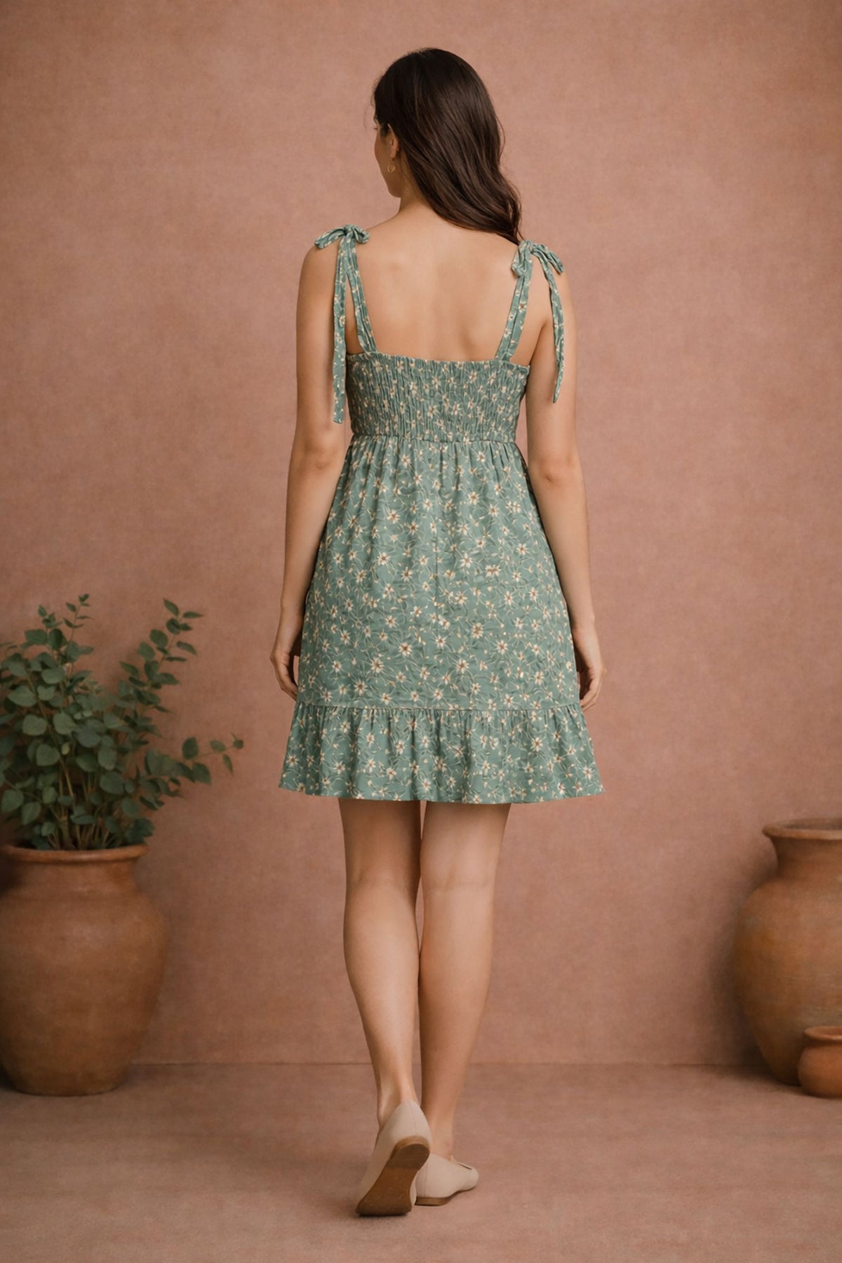 Women’s sage green floral rayon mini dress back view with tie-up shoulder straps and smocked back detail