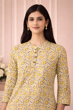 SN139 women’s mustard floral cotton kurta with round neckline and wooden buttons, closeup pose.