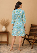 Back view of ivory A-line dress with all-over turquoise teal botanical vine print and three-quarter sleeves