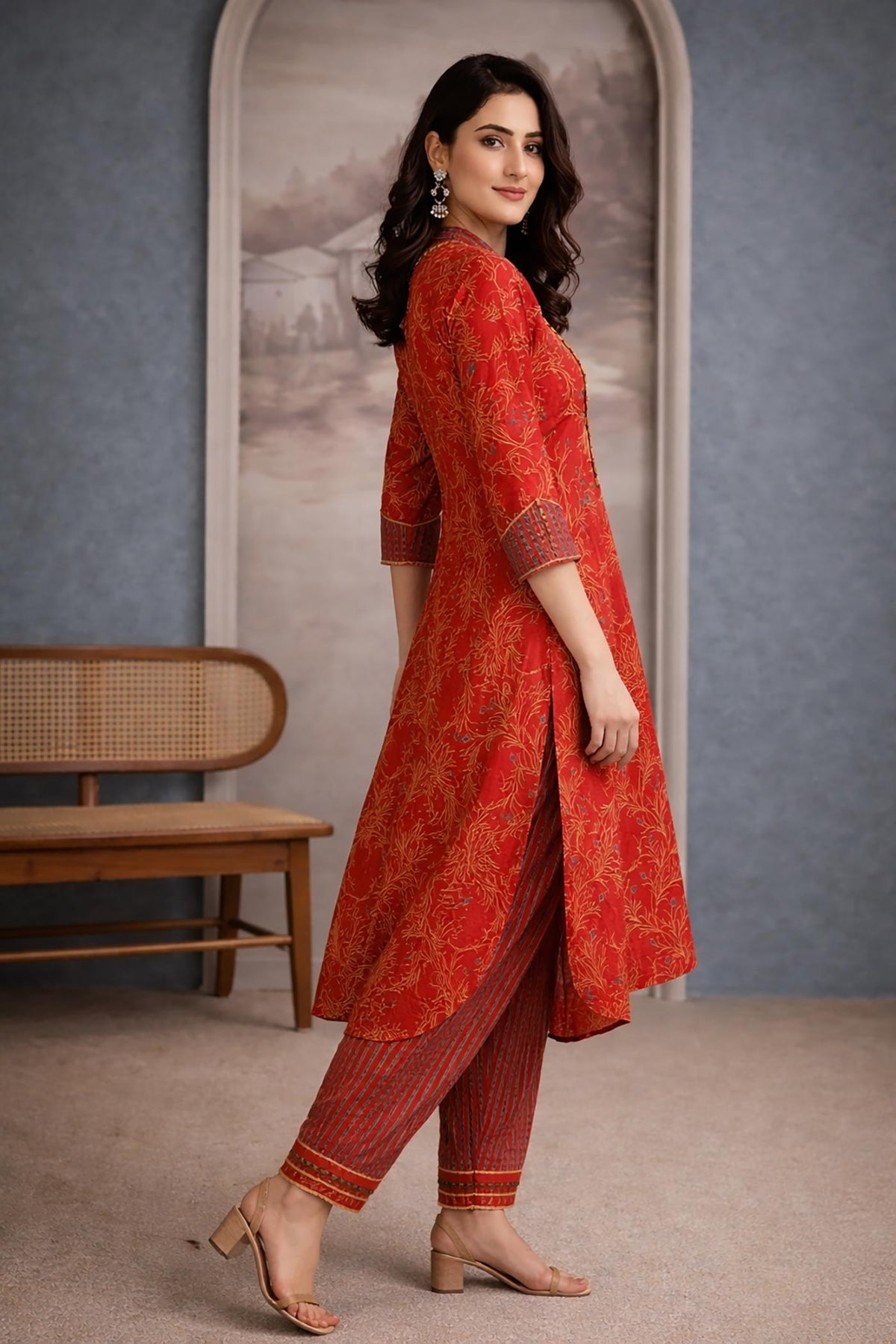 SN214 women’s vermilion red cotton kurta pant set with A-line silhouette and striped pants side pose