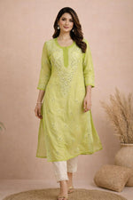 SN247 women’s lime green chiffon kurta walking pose with embroidered front panel and relaxed straight silhouette