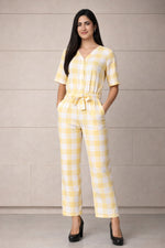 SN26 women’s pastel yellow gingham cotton jumpsuit with V-neck and short sleeves front pose