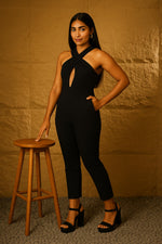 SN29 women’s black halter neck jumpsuit with fitted waist and ankle length pants, side pose