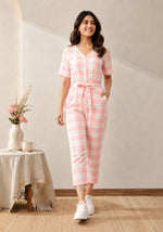 SN31 women’s pink gingham V-neck short sleeve jumpsuit with relaxed fit – walking pose