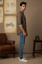 SN325 brown cotton floral print men’s mandarin collar shirt side pose with rolled sleeves and denim jeans
