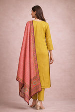 Mustard yellow kurta set with plain back, pink printed dupatta draped, back view with block heels