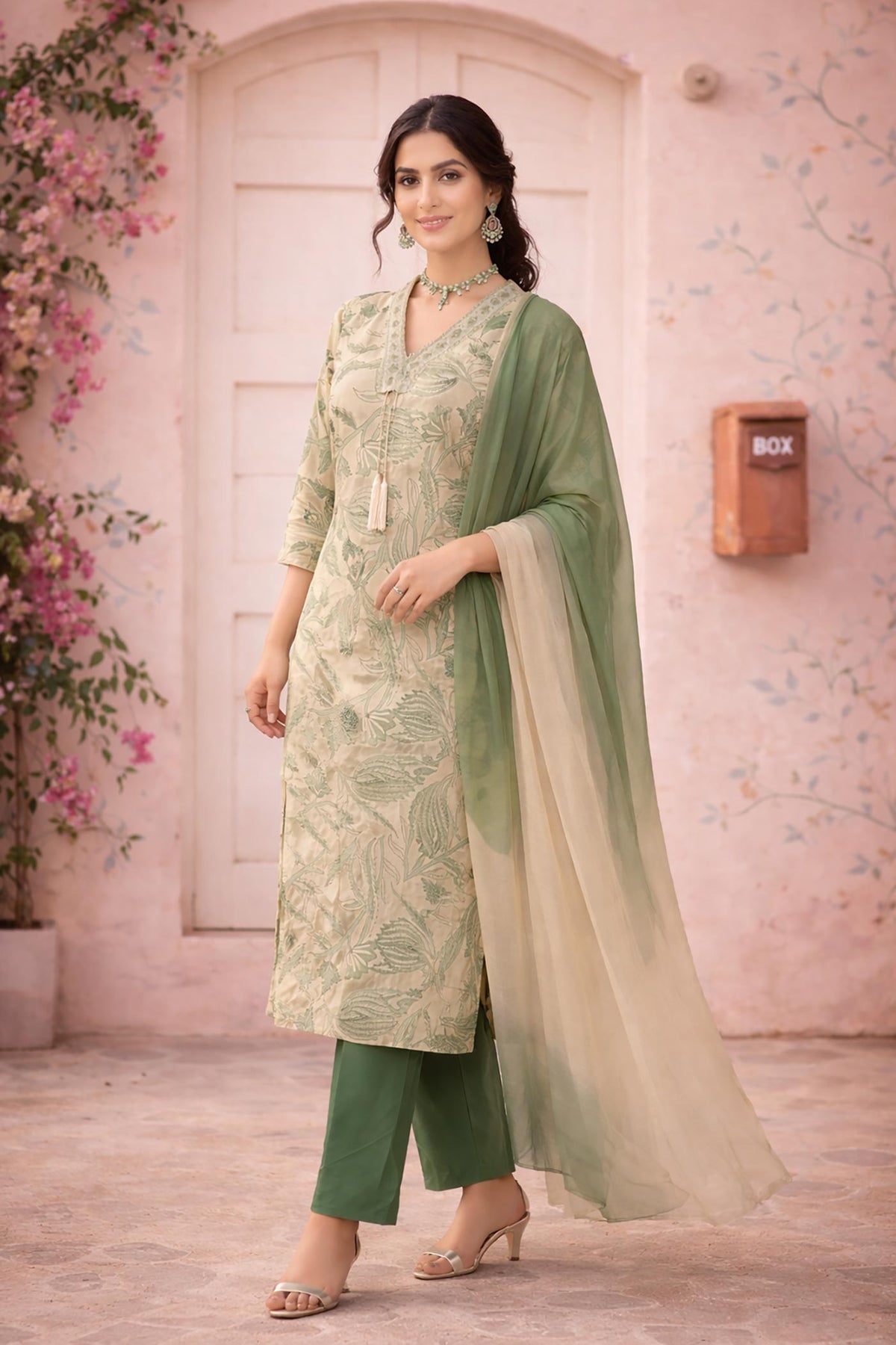 Left side pose of sage printed kurta set with chiffon ombre dupatta and straight pants.