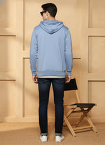Men’s powder blue hooded zip hoodie, back view showing ribbed hem, long sleeves, and dark denim styling.