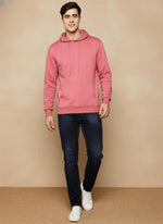 SN362 men’s rose pink cotton fleece hoodie styled with dark jeans and sneakers, walking pose.