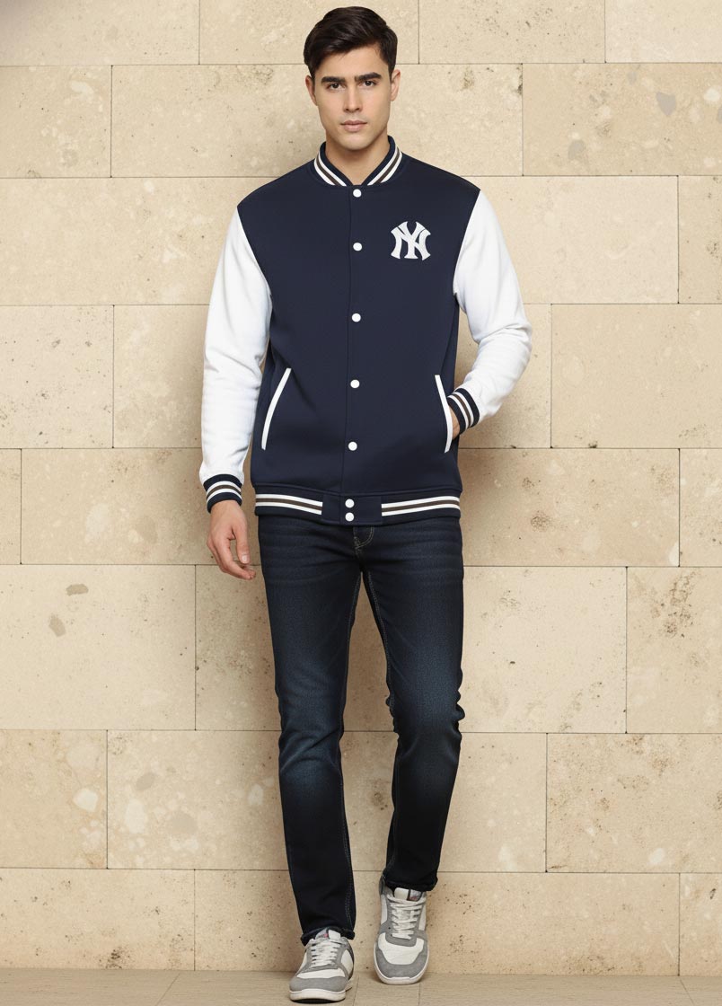 SN365 men’s navy cotton blend varsity jacket long sleeve walking pose styled with dark jeans and sneakers