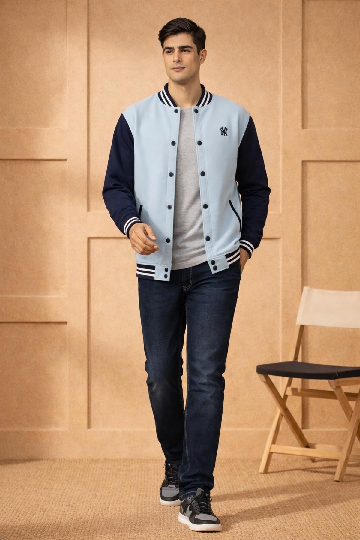 SN366 men's cotton fleece varsity bomber jacket, powder blue and navy slim fit, walking pose with sneakers