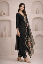 Black embroidered kurta set side angle, scalloped border detail, sheer dupatta drape, beige block heels.