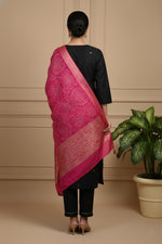 Black kurta set back view with pink bandhani dupatta drape and straight pants styling.