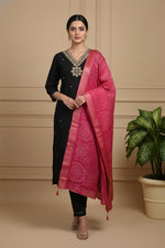 Black silk blend kurta set with gold neckline embroidery and pink dupatta, front pose.