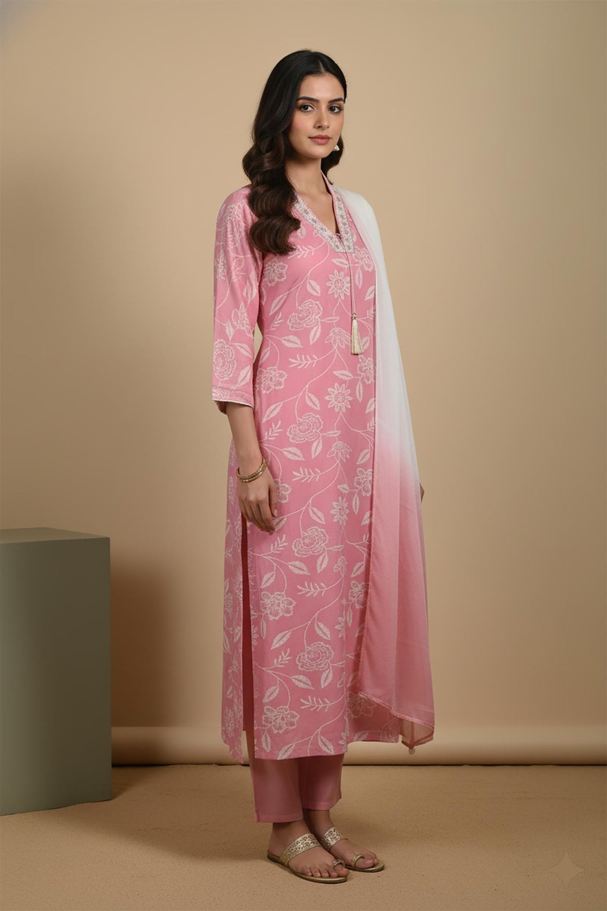 Blush pink printed kurta set with side slit, three-quarter sleeves, ombre dupatta, styled with metallic flats, side view.