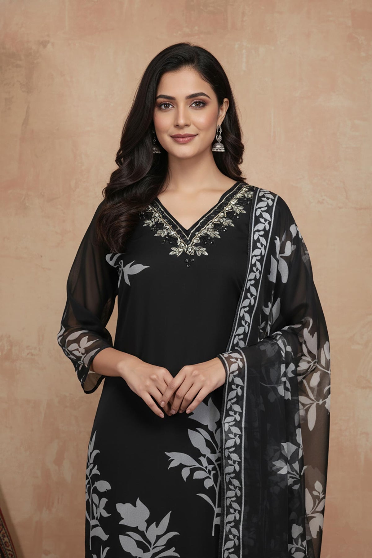 Close-up of black kurta embroidered V-neck with silver detailing and sheer printed dupatta.
