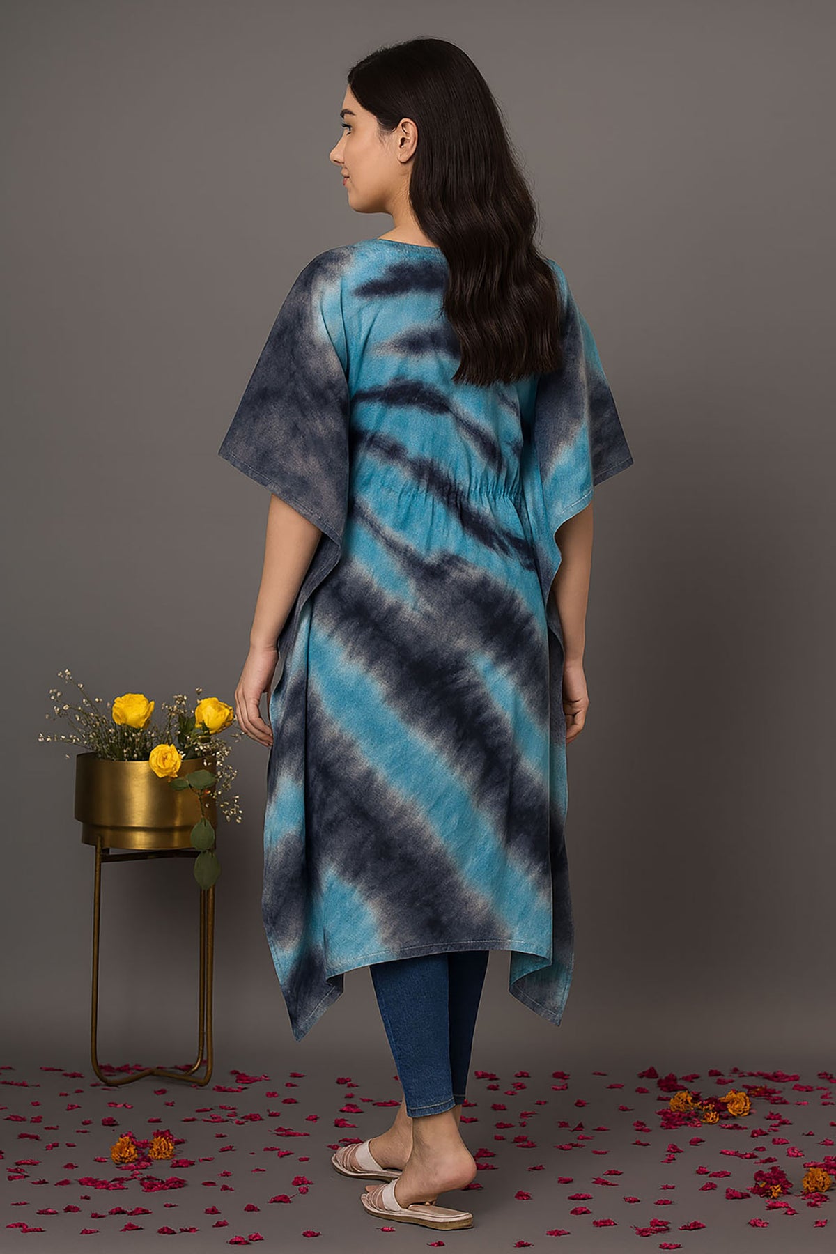 Back view of women’s blue and black tie-dye kaftan kurti with loose fit, short sleeves and asymmetrical hemline styled with jeans for casual wear