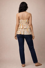 Multicolor layered peplum camisole back view with elastic waist, paired with dark blue jeans.