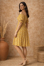 Side view of mustard floral off shoulder dress for women showing smocked bodice and fit and flare silhouette