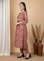 Side view terracotta floral kurta set with diamond print pants, relaxed A-line silhouette and black block heels.