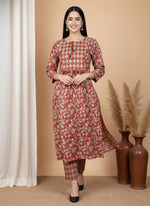 Terracotta floral kurta pant set with diamond yoke, model walking, three-quarter sleeves, black block heels.