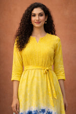 Close-up of yellow and blue tie-dye cotton midi dress with textured bodice and waist belt