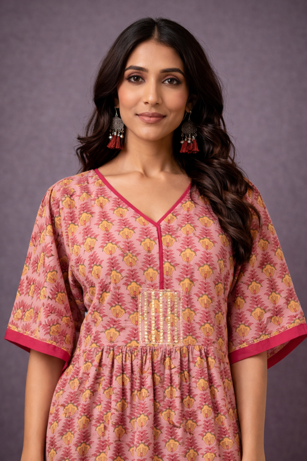 Close-up view of pink and mustard cotton handblock print kaftan kurti with V-neckline and empire waist detailing