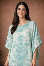 Close up of mint green tie dye kaftan dress showing neckline and fabric detail