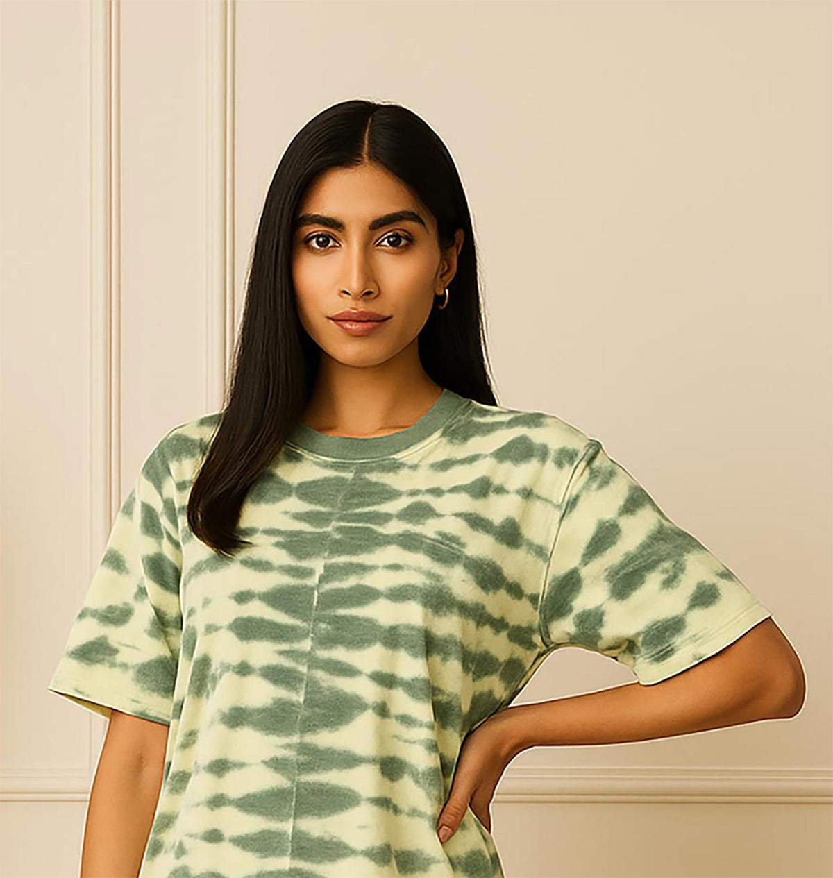 Green tie-dye oversized T-shirt close-up showing crew neckline, soft cotton fabric texture, and abstract tie-dye pattern.
