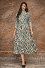Women’s teal & beige geometric cotton midi dress in walking pose showing natural fabric movement and flow