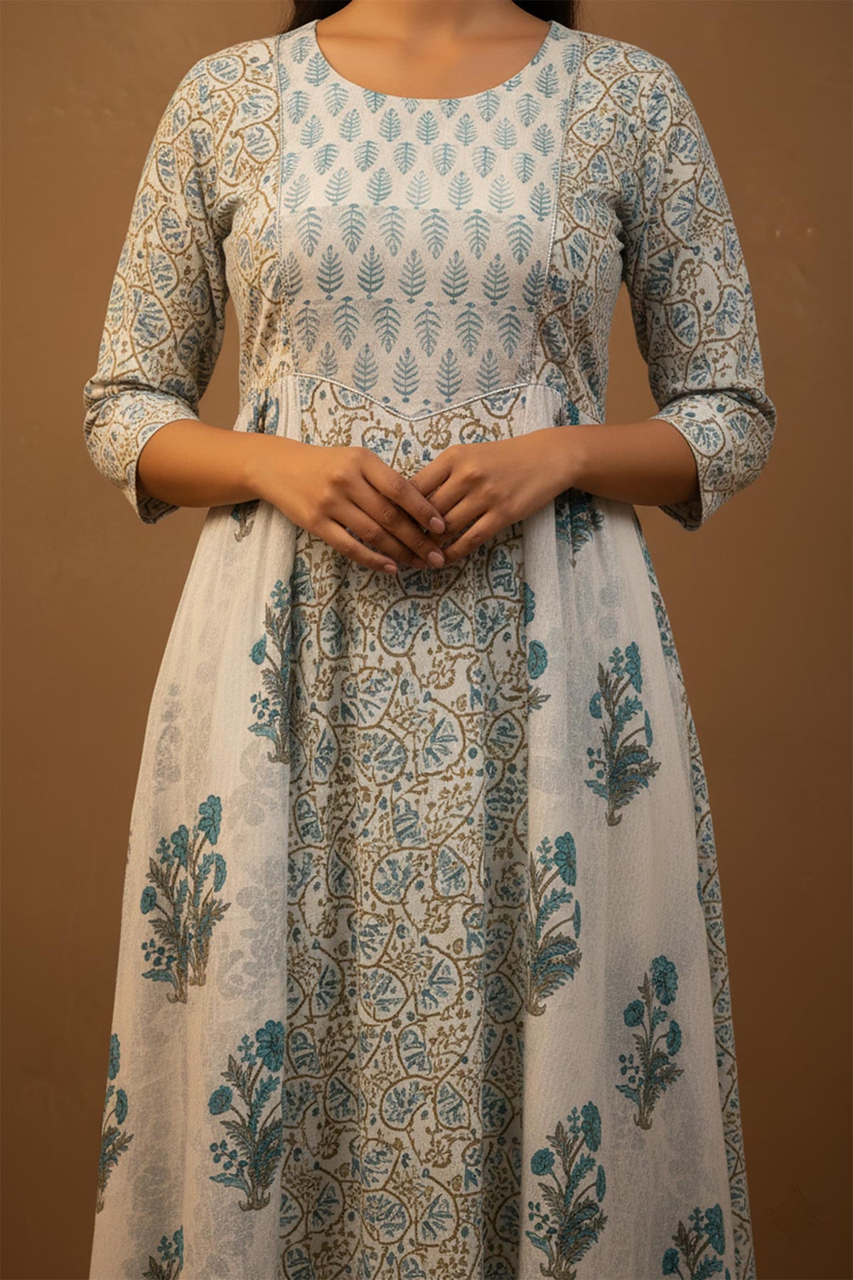 Woman wearing a floral patterned dress against a brown background