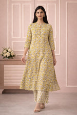 SN139 women’s mustard floral cotton kurta pant set styled with block heels, walking pose.