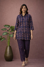 SN180 women’s indigo cotton kurta pant co-ord set walking pose with ankle-length pants and block heels