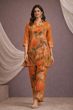 SN182 women’s burnt saffron floral silk blend co-ord set walking pose with V-neck kurta and wide pants