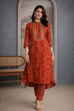 SN214 women’s vermilion red cotton kurta pant set with high-low hem and tapered pants walking pose