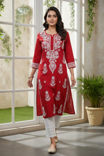 SN239 women’s crimson red cotton kurti with Chikankari embroidery styled in walking pose