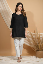 SN252 women’s black cotton embroidered short kurti with round slit neckline and three-quarter sleeves, front pose.