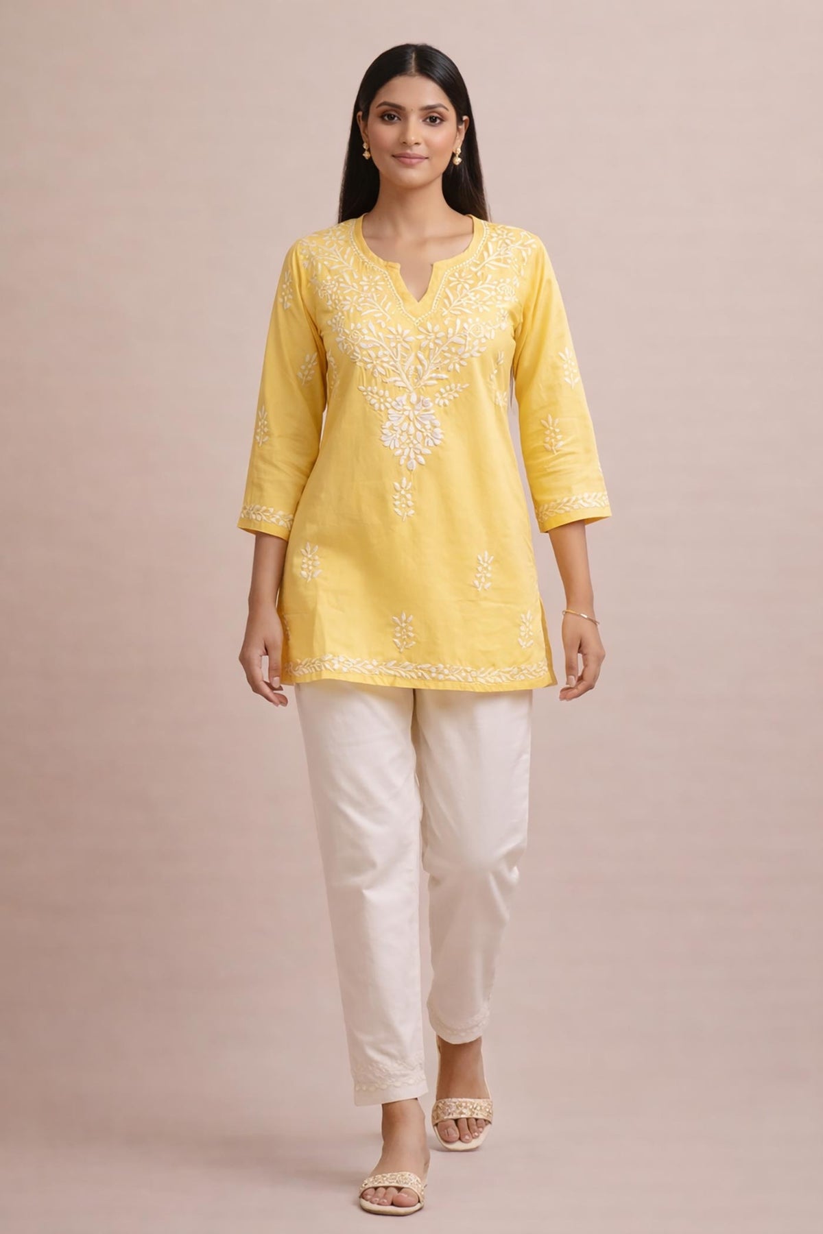 SN253 women’s butter yellow cotton chikankari kurti walking pose with V-neck and relaxed silhouette