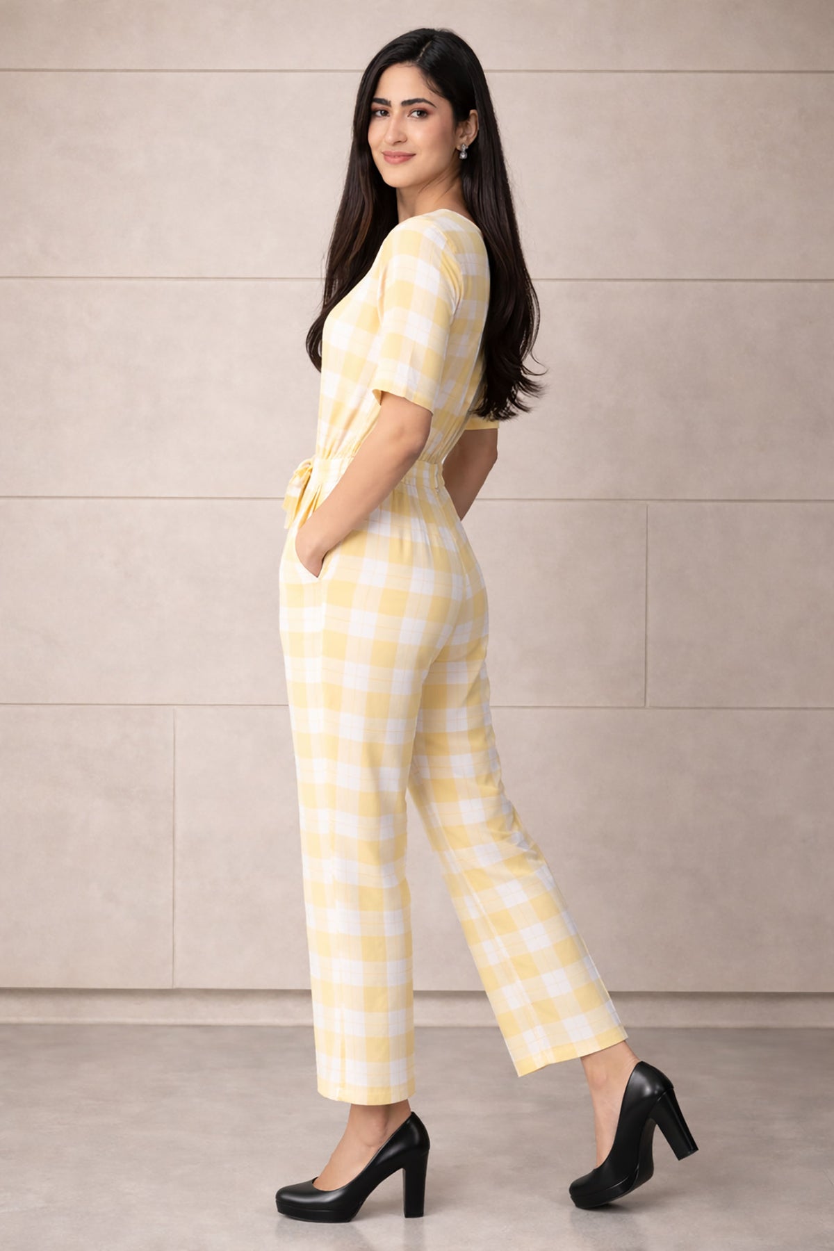 SN26 women’s pastel yellow gingham cotton jumpsuit side pose showing fit and silhouette