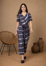 SN30 women’s black and white tie-dye V-neck jumpsuit with waist tie – walking pose