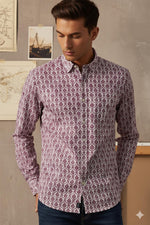 Close-up of purple geometric printed cotton shirt fabric showing intricate pattern and button-down collar.