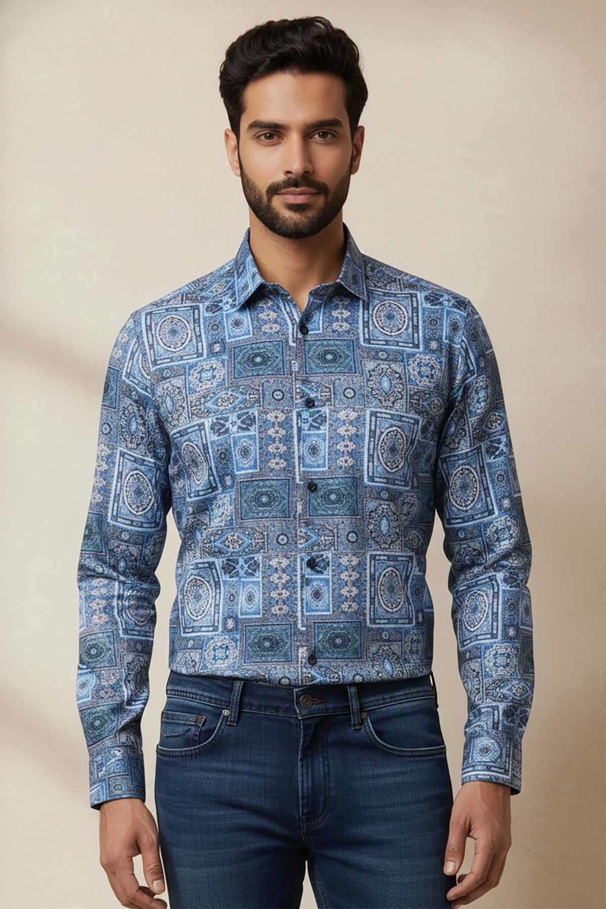 Close-up of blue geometric mosaic printed men’s shirt showing detailed tile pattern and button-down collar.