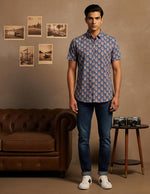 SN326 men’s slate blue cotton floral print short sleeve shirt front pose with dark denim and white sneakers