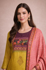Mustard yellow kurta with detailed floral yoke and pink dupatta border, close-up view