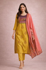 Mustard yellow printed kurta set with dupatta, walking pose front view with beige heels