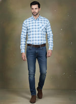 SN336 men’s light blue cotton checkered shirt walking pose styled with dark denim and brown shoes.