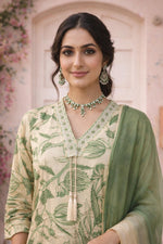 Close-up of sage printed kurta set featuring embroidered V-neck and tassel dori detail.