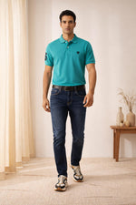 SN345 men’s turquoise cotton piqué polo t-shirt walking pose, short sleeve, modern fit, styled with jeans and sneakers
