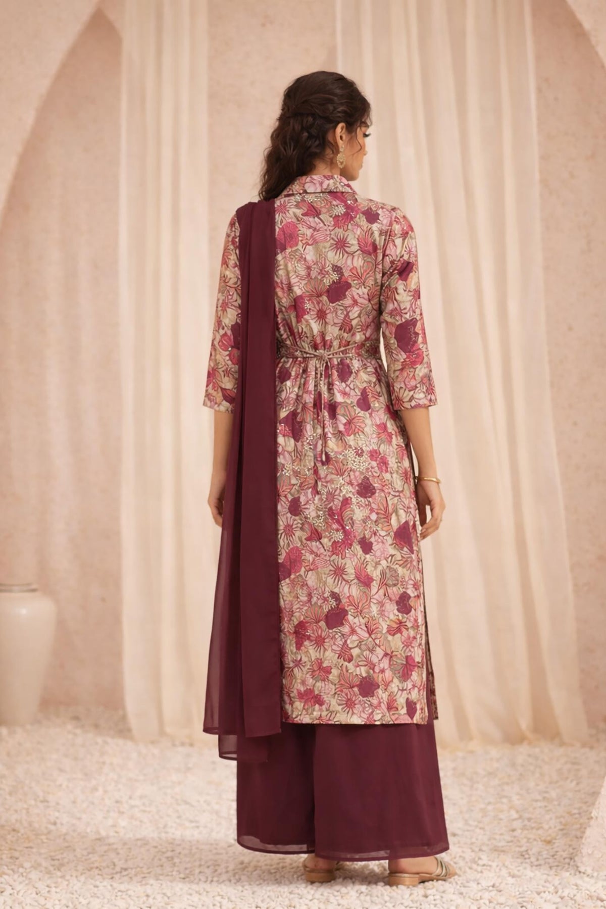 Floral maroon kurta set back view with tie waist detail and flowing chiffon dupatta.